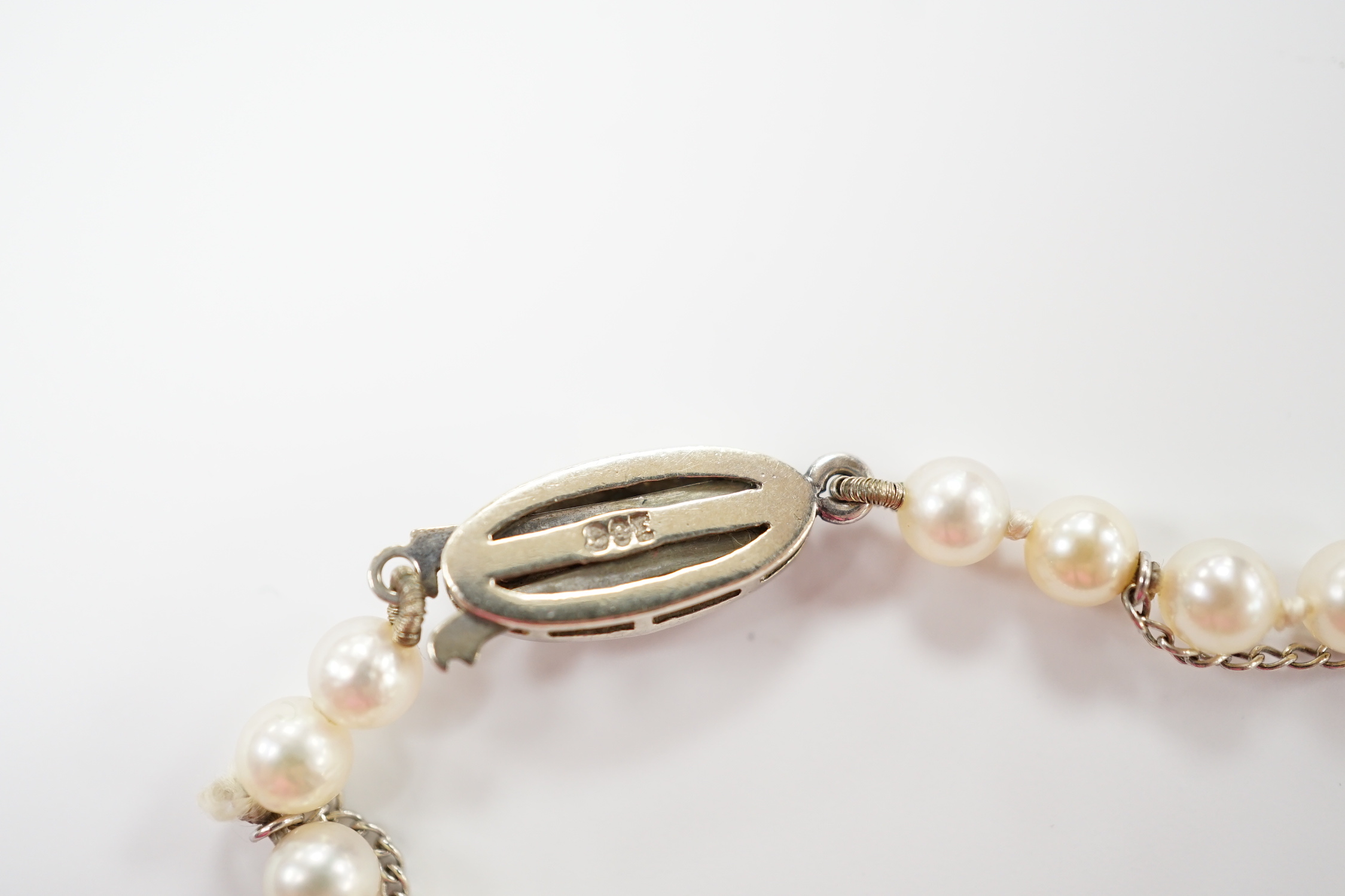 A single strand graduated cultured pearl necklace, with single stone diamond chip set 9ct white metal clasp, 46cm.